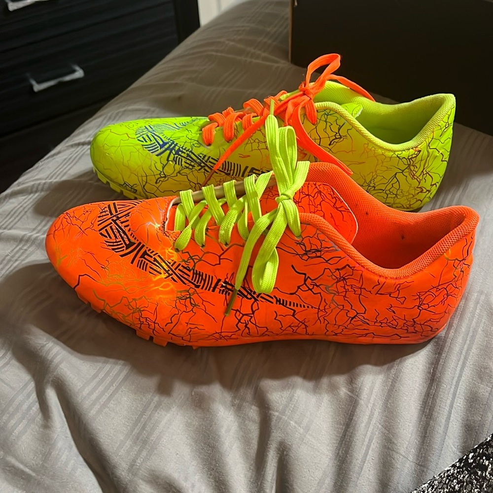 Green and orange storm z sprint track spikes